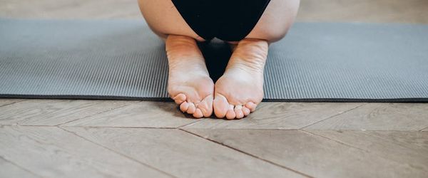 A person sitting in a meditative pose at the end of a session.