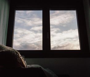 View of a window with natural light streaming into a quiet room.